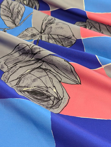 Fabric with floral pattern on a blue and pink check