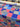 Roll of floral-patterned fabric with a checkered background