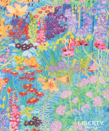 A close-up of colorful floral fabric with a dense wildflower pattern in blue, green, pink, purple, yellow, orange, and red. The Liberty Fabrics logo is visible in the bottom right corner.