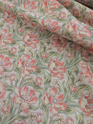 Floral patterned fabric with pink and green flowers on a neutral background