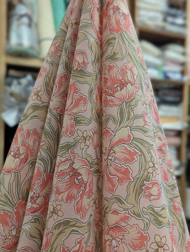 Floral patterned fabric with pink and green colors in a store setting