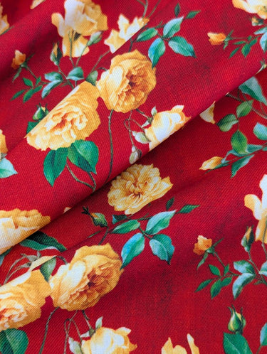 Close-up of a printed wool fabric with yellow flowers on a red background