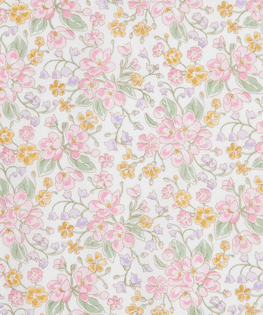 A repeating floral pattern featuring pink blossoms, small yellow flowers, and green leaves on a white background.