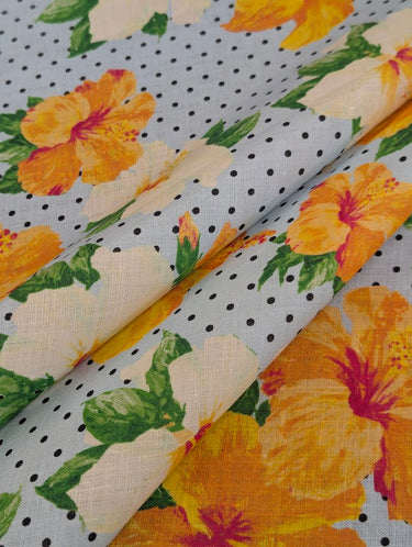 Floral fabric with yellow and white flowers on a polka dot background