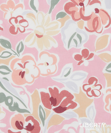 A close-up of Liberty Fabrics floral pattern featuring stylized flowers and leaves in pink, peach, cream, sage green, and burgundy on a light pink background.