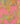 A close-up of a pink patterned fabric or wallpaper featuring ornate paisley and floral motifs in gold, teal, and orange, with a gold metal ruler standing vertically on the right side for scale.