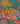 A close-up of a colorful Liberty Fabrics floral and botanical pattern with stylized trees, flowers, leaves, and small figures on a bright multicolor background. The Liberty Fabrics logo appears in the bottom right corner.
