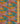 A close-up of Liberty Fabrics featuring a vibrant, multicolor floral and botanical pattern with peacocks, displayed with a wooden ruler on the right side for scale.