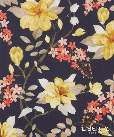 A close-up of Liberty Fabrics floral pattern featuring yellow magnolia flowers, coral pink blossoms, and cream leaves on a dark navy background.