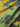 Close-up of a textured fabric with green, yellow, and blue colors.