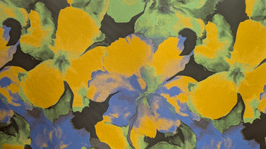 Large colourful abstract florals with yellow, green, and blue colours on a textured background.