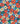 Floral pattern with red poppies, white daisies, and blue flowers on a navy background, featuring the Liberty Fabrics logo.