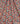 A close-up of a fabric surface with an allover floral print. The pattern features orange-red roses, white daisies with yellow centers, and small green leaves on a blue background.