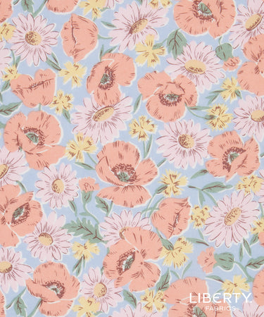 Liberty Fabrics floral pattern fabric featuring peach poppies, light pink daisies, and small yellow flowers on a light blue background.