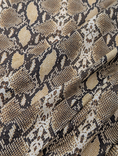 Close-up of a silk-blend cotton batiste fabric with a snake skin pattern