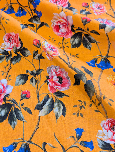 Floral patterned fabric with pink and blue flowers on a orange background