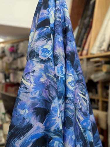 Pure wool floral fabric draped within a store setting