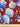 Printed pure wool fabric featuring blue and white flowers on a red background, shown with a ruler for scale.