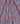 A close-up of draped fabric featuring a dense, colorful Art Nouveau floral pattern with pink, blue, red, yellow, and green motifs.