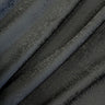 Close-up of a black textured fabric with a subtle starry pattern.