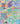 A close-up of colorful floral fabric with a dense wildflower pattern in blue, green, pink, purple, yellow, orange, and red. The Liberty Fabrics logo is visible in the bottom right corner.