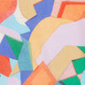 A close-up of Liberty Fabrics' abstract geometric pattern featuring overlapping shapes in orange, yellow, blue, green, pink, and light blue.