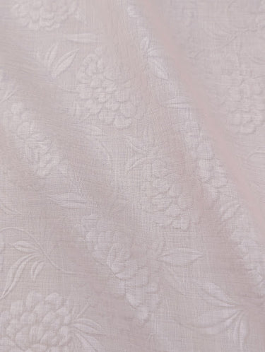 Textured floral fabric on a light pink background