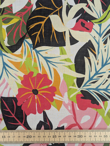 Printed pure cotton fabric with a colourful tropical pattern, shown with a ruler at the bottom for scale