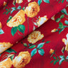 Close-up of a printed wool fabric with yellow flowers on a red background