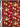 Close-up of a printed wool fabric with yellow flowers on a red background, featuring the brand 'Emanuel Ungaro' on the selvedge.