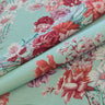 Floral fabric with pink and red flowers on a pastel background