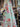 Floral fabric with pink and red flowers on a pastel background, draped in a store setting.