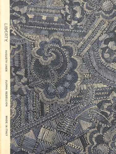 Patterned fabric with geometric and floral design, featuring the brand 'Liberty'.