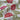 Floral fabric with red flowers and green leaves on a white background