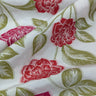 Floral fabric with red flowers and green leaves on a white background