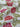 Floral fabric with red flowers and green leaves on a white background