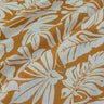 Close-up of a printed pure cotton fabric with ivory botanical print on a mustard base.
