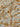 Close-up of a printed pure cotton fabric with ivory botanical print on a mustard base.