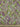 A linen fabric with an intricate paisley pattern in warm, earthy tones of muted greens, purples, and pinks, accented by floral motifs, and a ruler shown for scale.  