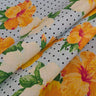 Floral fabric with yellow and white flowers on a polka dot background