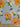 Floral fabric with yellow and white flowers on a polka dot background, ruler at the bottom for scale.