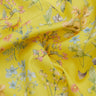 Yellow Liberty Fabrics floral print fabric with delicate watercolor-style flowers and leaves in pink, blue, green, and peach tones, shown with soft folds.