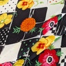 Colorful floral pattern on a black and white checkered silk crepe de chine fabric