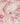 A close-up of draped fabric with a soft floral print in pastel pink, peach, white, coral, and muted green. The Liberty Fabrics logo is visible in the bottom right corner.