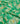Green silk-like fabric with an ornate gold and light blue floral paisley pattern, draped in soft folds.