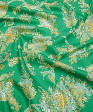 Green silk-like fabric with an ornate gold and light blue floral paisley pattern, draped in soft folds.