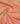 Pink fabric with an ornate paisley and floral pattern in gold, teal, and orange, draped to show its texture and sheen.