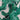 Close-up of a fine printed cotton lawn fabric with green banana leaves on a white background