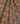 A close-up of draped Liberty Fabrics featuring a vibrant, multicolor floral and paisley pattern with yellow, teal, pink, and orange tones.