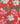 A close-up of a Liberty Fabrics floral pattern featuring cream magnolia flowers, pink blossoms, and green leaves on a vibrant red background.